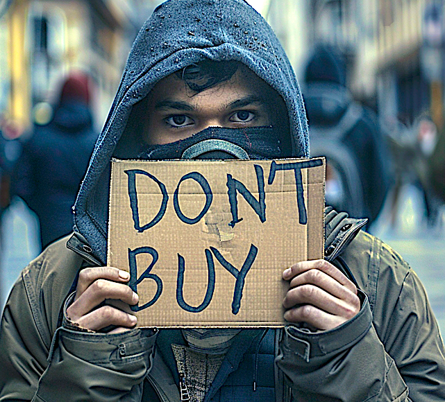 Man holds up a cardboard sign that says, "DON'T BUY." Image produced using Midjourney