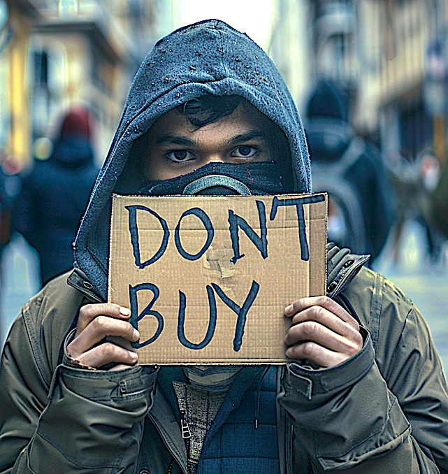 Man holds up a cardboard sign that says, "DON'T BUY." Image produced using Midjourney